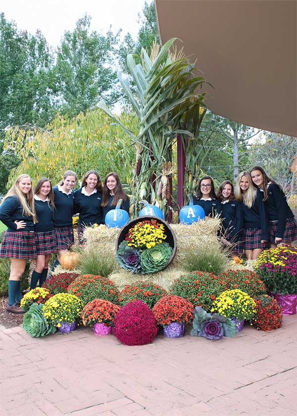 Students standing behind fall display